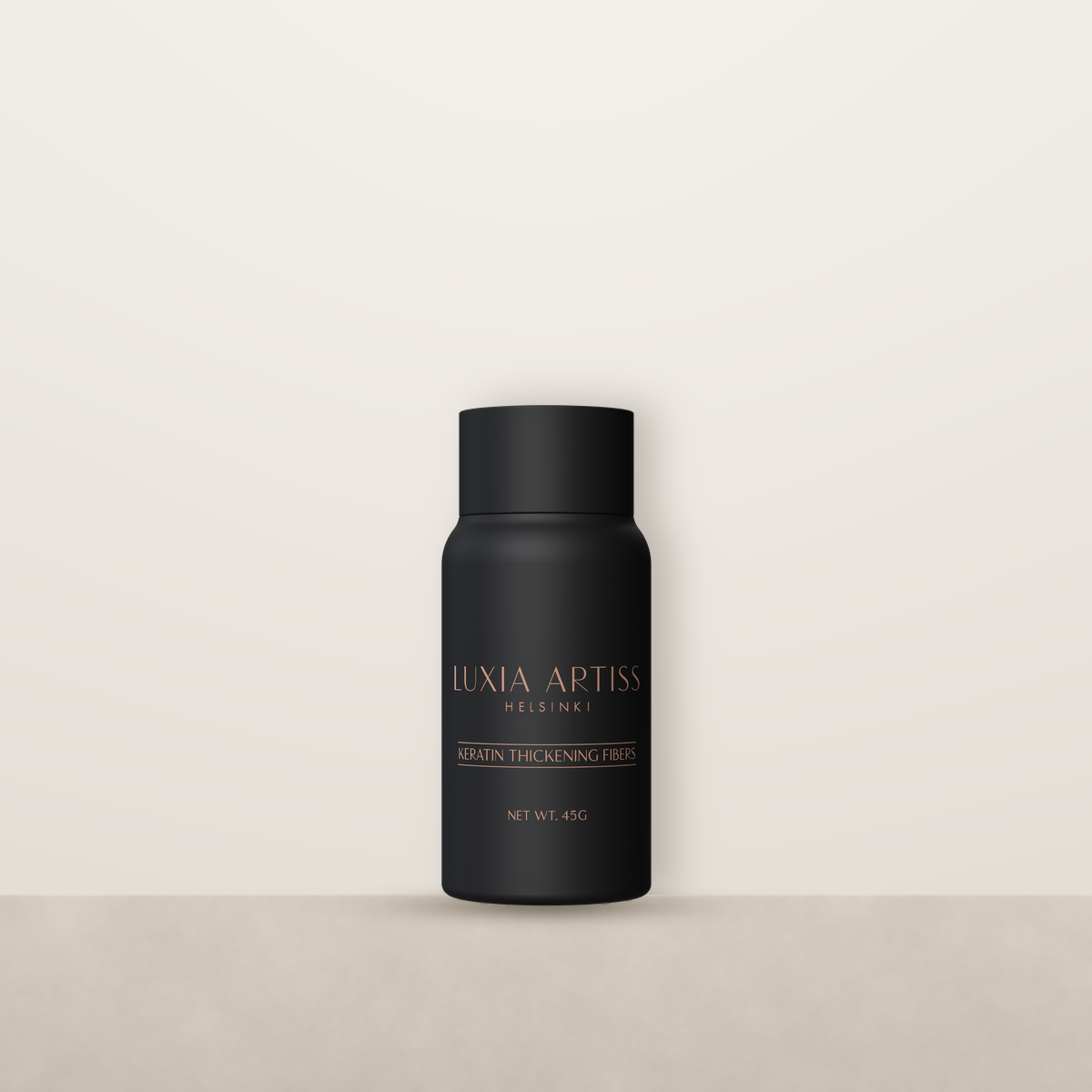 Luxia Artiss Keratin Thickening Fibers bottle on a stone ledge