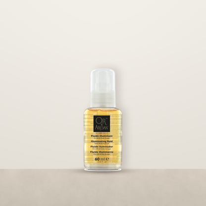 OR &amp; Argan Fluide Illuminant pump bottle on a stone ledge