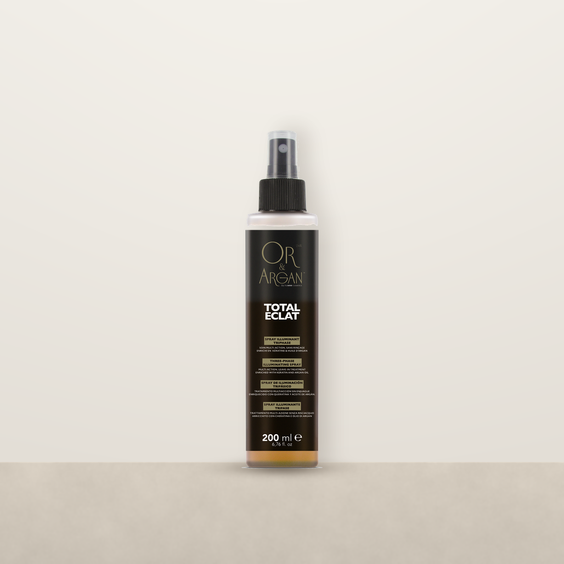 OR &amp; Argan Total Eclat three phase illuminating spray on a stone ledge