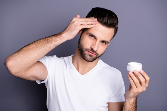 iStock 1157136152 man applying cream to hair for hairloss - Learn to Avoid Consumer Fraud in the Hair Loss Industry